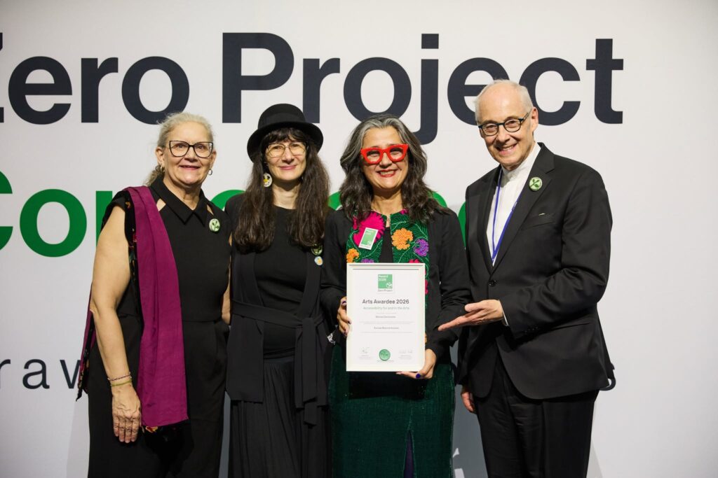 Lorena Martínez Mier EBA project manager, receives the award from three other people, two women and a man
